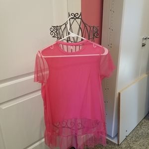 Unique tunic with sheer ruffle.